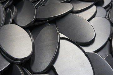 Industrial background. Close up of metal car parts in a warehouse. Stack of new and shiny steel...