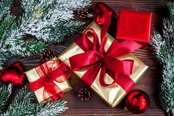 gifts boxes with fir branches on wooden background top view