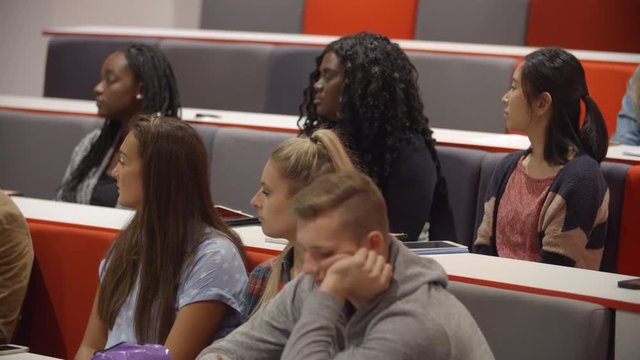 Close up of students sitting in a university lecture theatre