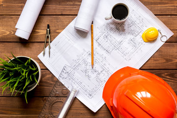 Engineer wooden working desktop with drawings apartments top view