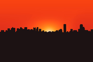 Silhouette of the city on the sunset background