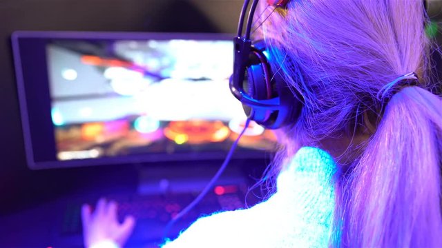 Teenage girl enthusiastically playing a computer game.