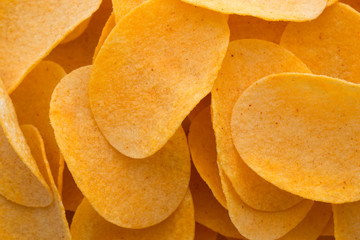 Close up potato chips on wood top view background.