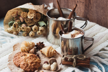 Metal mugs with cacao and marshmallows