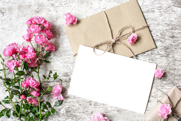 Bouquet of tender pink roses with a blank greeting card