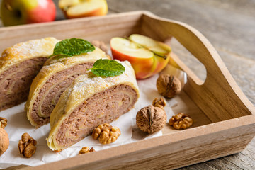Sweet strudel stuffed with walnut and apple filling