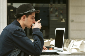 young man with the laptop in the coffee shop