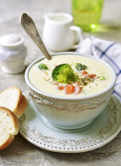 Vegetable chowder with cheese in a blue vintage bowl.