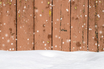 Winter background with snowfall on the old wooden barn wall and snowdrift