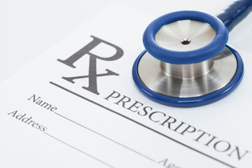 Medical prescription form and stethoscope on table