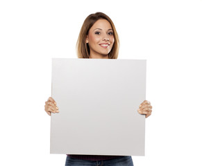 Naklejka premium young beautiful woman holding a blank board for advertising