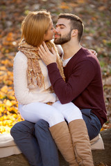 sensual outdoor portrait of young stylish fashion couple kissing