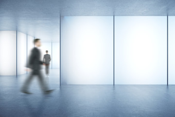 Fototapeta premium Businessmen in room with posters