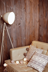 Fototapeta na wymiar Beautiful cozy home interior with sofa, Christmas cushions and garland