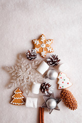 Fototapeta na wymiar Beautiful Christmas tree made of gingerbread, marshmallows and Christmas decoration on light background