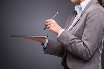 Businesswoman working on tablet computer in business concept