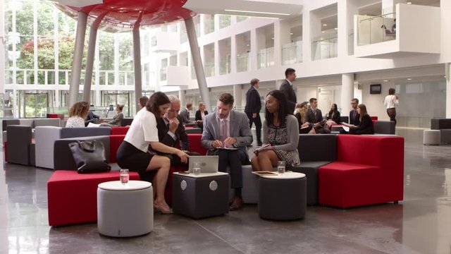 Businesspeople Meeting In Lobby Of Modern Office Shot On R3D