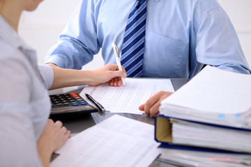 Bookkeepers or financial inspector making report, calculating or checking balance. Audit concept.