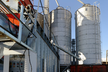 Plant for the drying of grain on the background of sky on a bright sunny autumn day