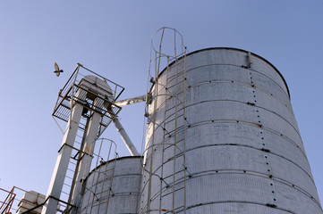 Plant for the drying of grain on the background of sky on a bright sunny autumn day