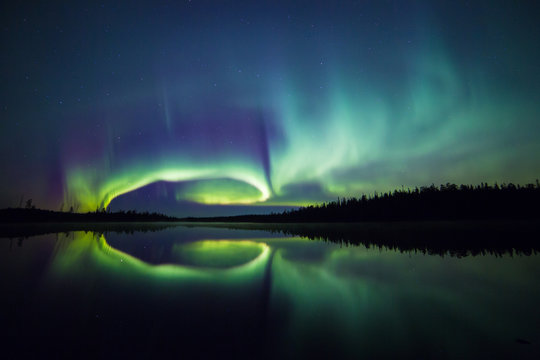 Northern lights reflected on lake, Lapland, Finland, Scandinavia, Europe 