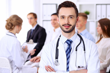Fototapeta premium Friendly bearded male doctor with patients