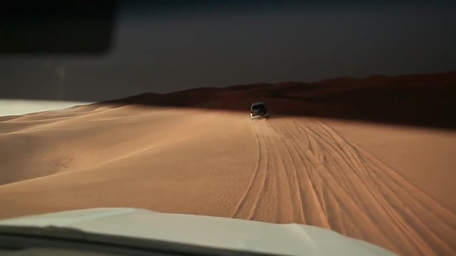 Desert Safari SUVs bashing through the arabian sand dunes. View from the car 10.