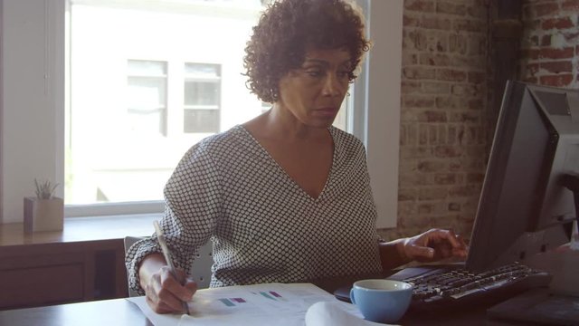 Mature Businesswoman Works On Computer In Office Shot On R3D
