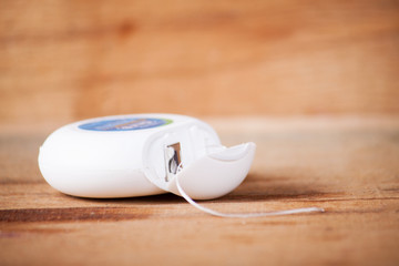 Dental floss isolated on wood board