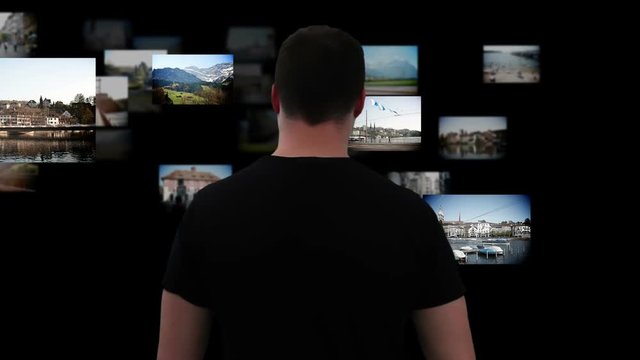 Young Man Organizing Photos With Futuristic Computer