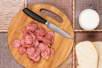 Sliced sausages with bread and yogurt for breakfast