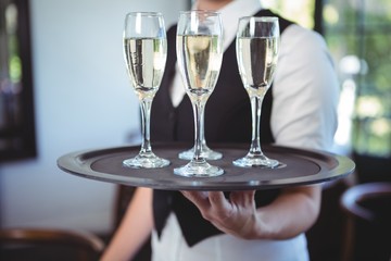 Waitress with a tray of flute of champagne