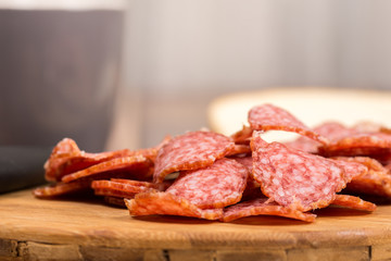 Sliced sausages on the wooden board with bread