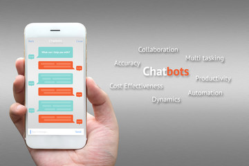 Chat bot benefit and future marketing concept. Businessman hand holding white phone with chatbot infographic and application with gray aluminium background.