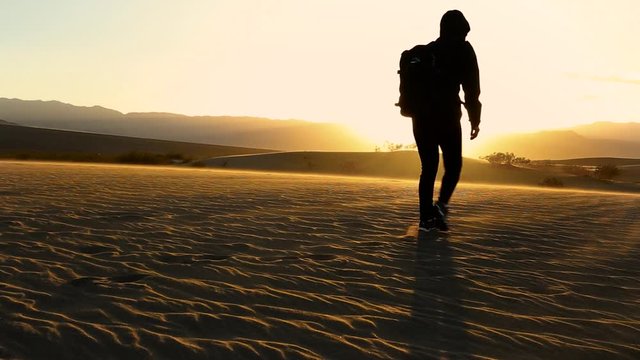 woman walking on a sand dune in the death valley