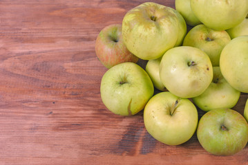 Fresh green apples on wooden background