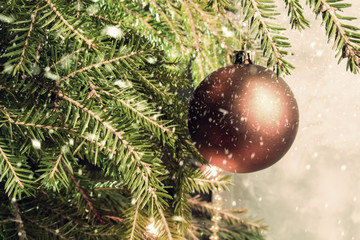 Christmas ball on a Christmas tree. Falling snowflakes