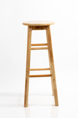 Wooden bar chair isolated on white background. Wooden light pine dining stool. Natural, solid wood bench.