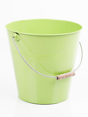 Green iron/metal bucket/pail/container with handle isolated on white background. Colorful kid child toys. Garden equipment.