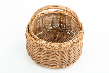 Empty wooden woven fruit/bread basket on white background. Wicker basket. Plaited container. Natural wood (brown) color. Christmas, New Year, enterteinment place decoration.  Side view,overturned 