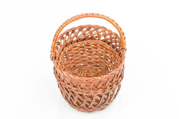 Empty wooden woven fruit/bread basket on white background. Wicker basket. Plaited container. Natural wood (brown) color. Christmas, New Year, enterteinment place decoration.  Side view,overturned 
