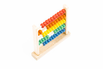 Traditional abacus with colorful wooden beads on white background. Toy abacus to learn counting. Colorful children counting frame for kids. Top side view.