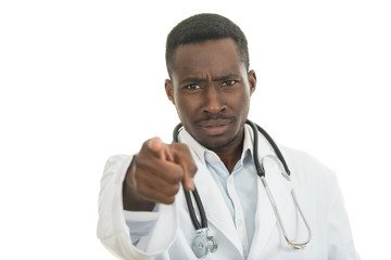 Angry african black male doctor pointing finger at you with stethoscope around his neck