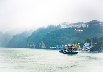 Cargo ship cruising on Yangtze river in rainy day