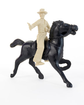 Plastic cowboy on horse. Vertical.