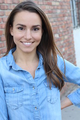 Portrait Of Pretty Young Woman Standing By Wall