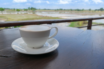 Close up white cup of Coffee, latte on the wooden table