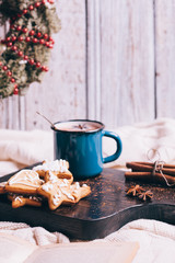 gingerbread and mug with cacao on wooden background