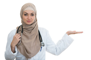 Closeup portrait of friendly, smiling confident Muslim female doctor pointing arm.