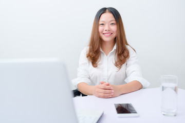 Young business woman working in office.